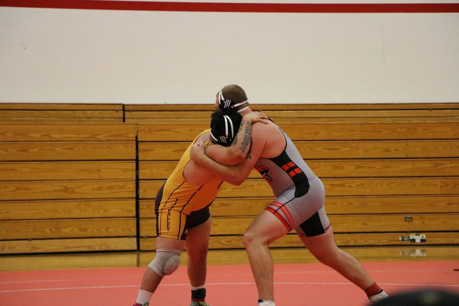 BC wrestler and Victor Valley wrestler grasp each other during a long duel.