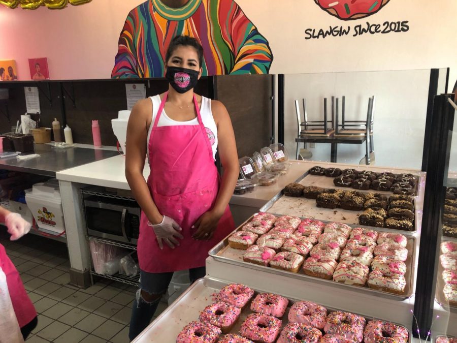 Owner of Sweet Beast Bakery, Melinda Chavez, posing with her donuts on the grand opening day on Sept.18.