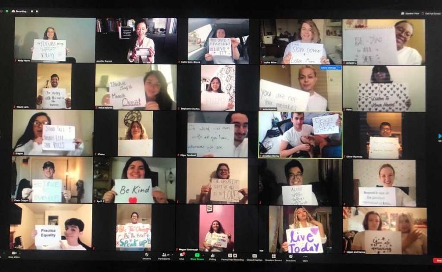 The Bakersfield Choirs rehearsing through Zoom while holding up inspirational quotes.