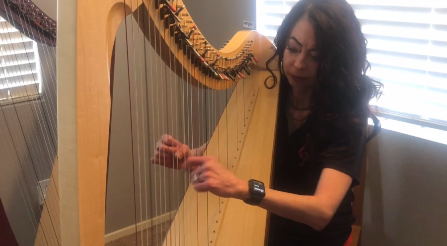 Music Department Chair Dr. Jennifer Garrett as she plays the harp.
