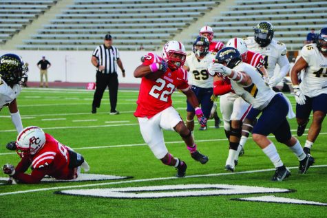 Running back Antonio Robinson evades defenders during Homecoming game on Oct. 16.