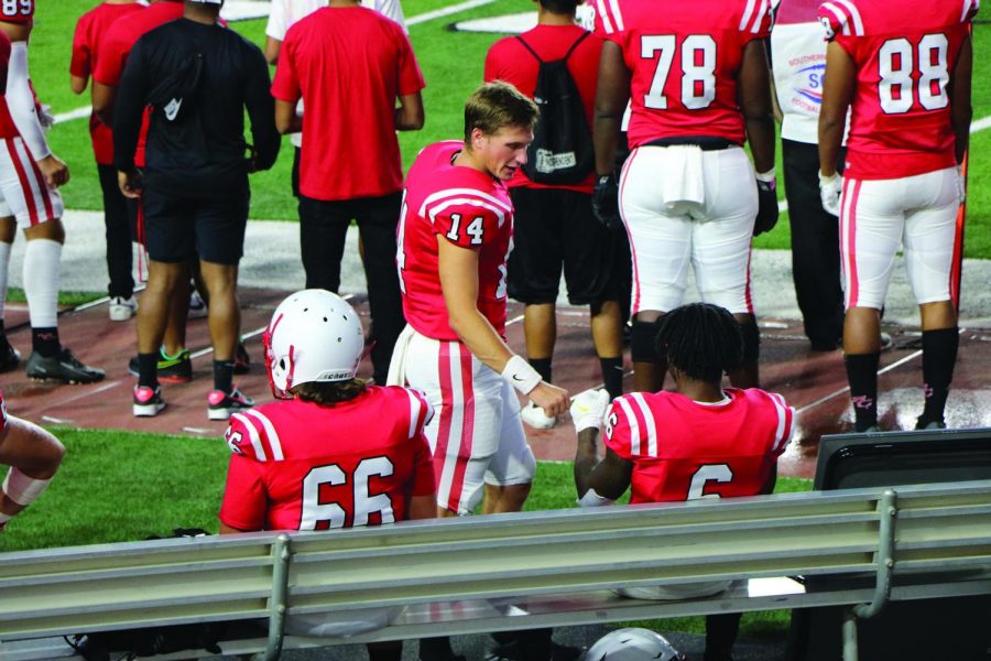 Quarterback Dexter Frampton fist bumps receiver Myran Randle on the sideline during victory vs. San Bernardino Valley

