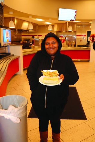 Monique Armstrong holds the food she just ordered from the cafeteria grill.