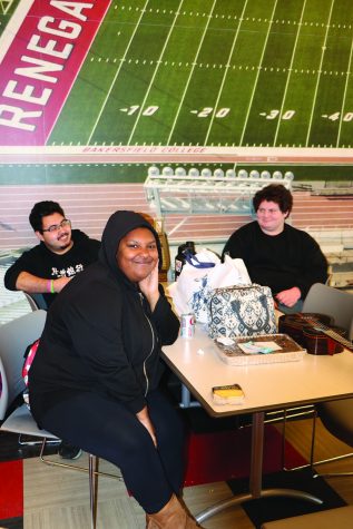 Monique Armstrong sitting with her friends Juan and Lan in the Dining Hall.