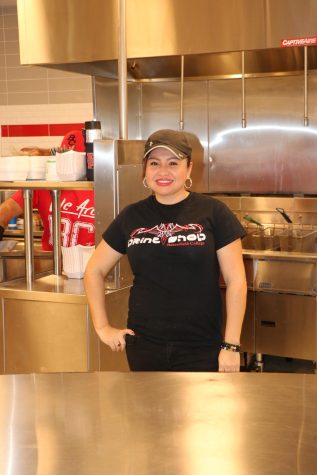 Mirian Fuentes, Assistant 3 at the BC cafeteria, posing behind the counter after lunch rush hour.