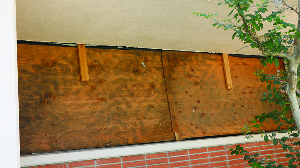 Wood boards are currently put up on office windows because of construction in the humanities building. 