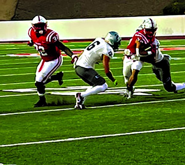 Number 32, Cleveland Cj Tolbert, running the ball past the 20-yard line.