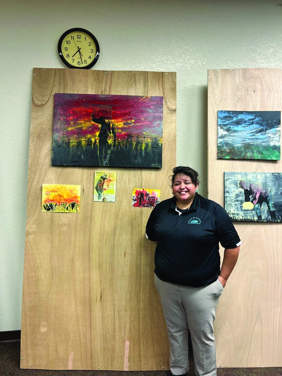 Montoya under her favorite piece, “Strawberries in Wildfires.”