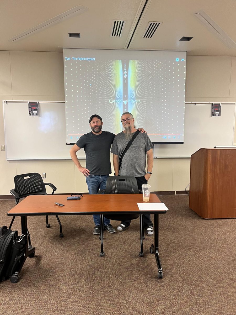 Kyle Burham (left) And Reggie Williams pose in front of TOOL’s “The Patient” video.