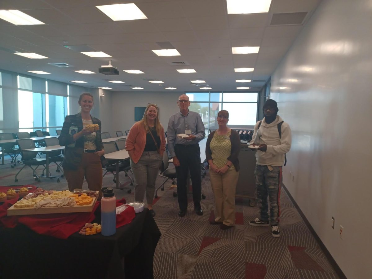 BC librarians and student Kevin Davis (right) enjoying refreshments after the event. 