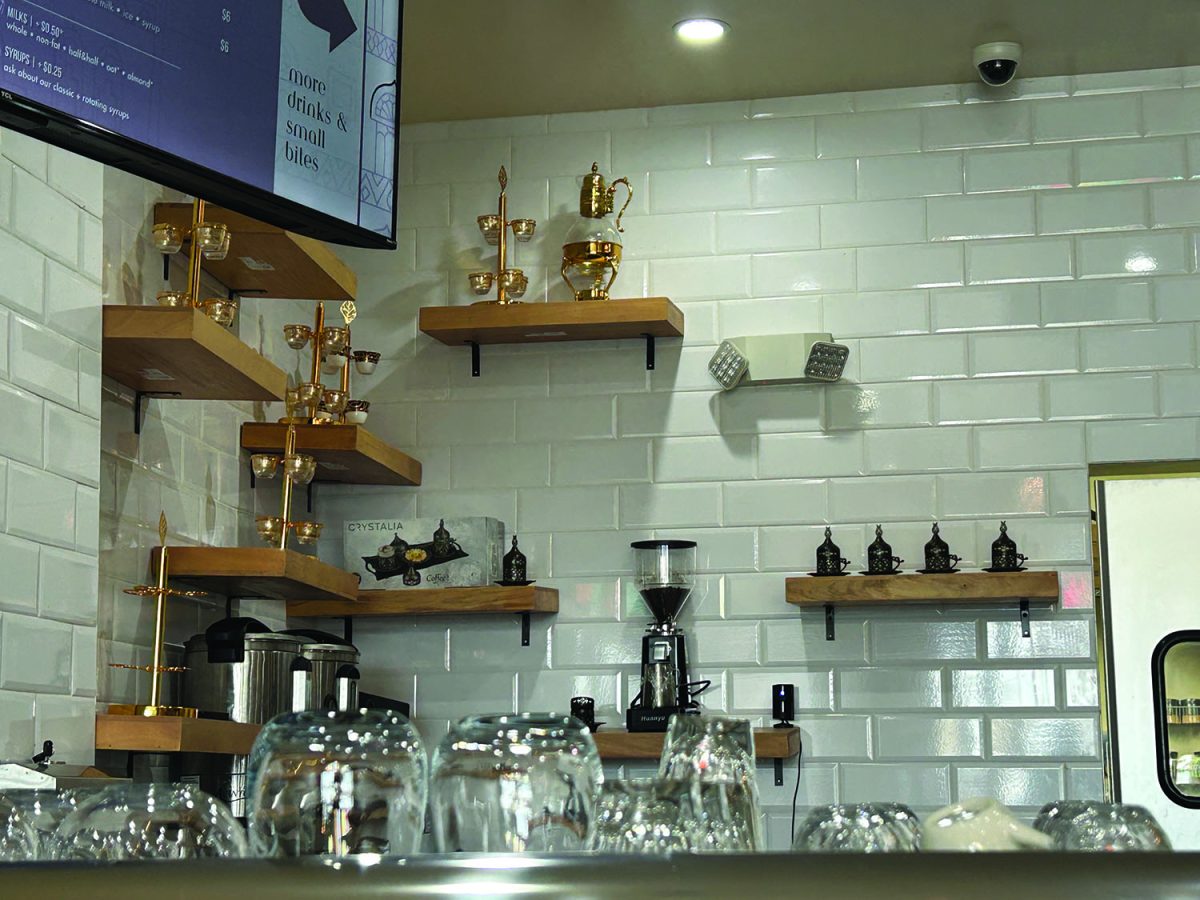 The back of the register with traditional Yemeni tea pots and sets on the shelves.