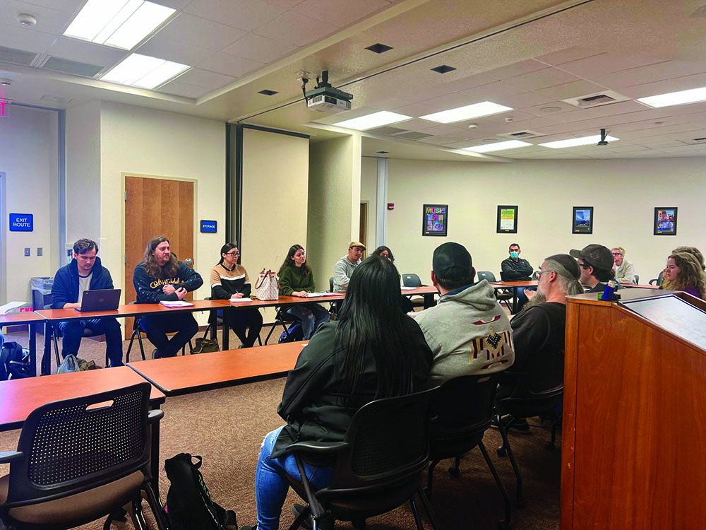 Professor Jeffrey Houston talks about Art while  students watch at the Gadfly Café on Feb. 7