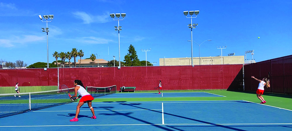 Kiana Lua and Niki Rusinová (server) play their doubles match against Santa Monica College.