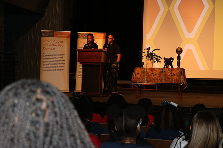 Umoja Club President and Vice President speak at the Umoja black history conference.