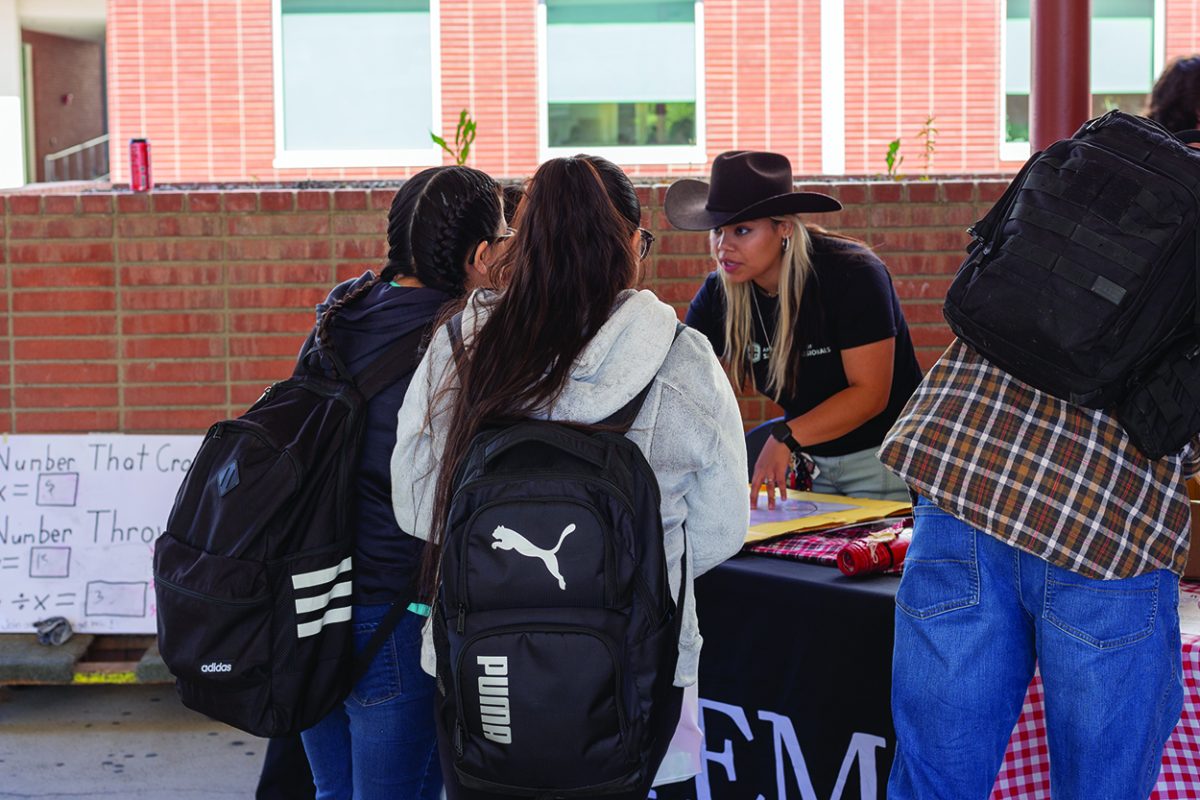 Arianna Perez, a new member of the Math Club, explaining her activity to a group of BC students.
