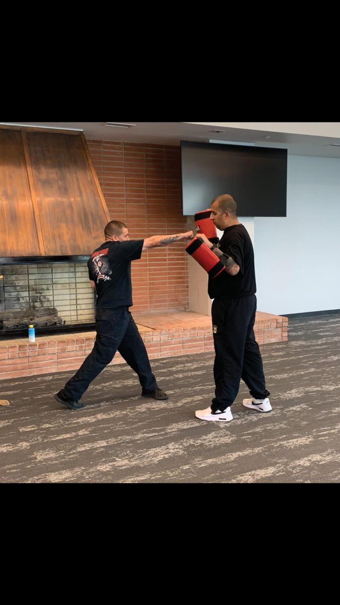 College safety officers Francisco Salazar and Ricardo Orozco demonstrating a dominant hand punch